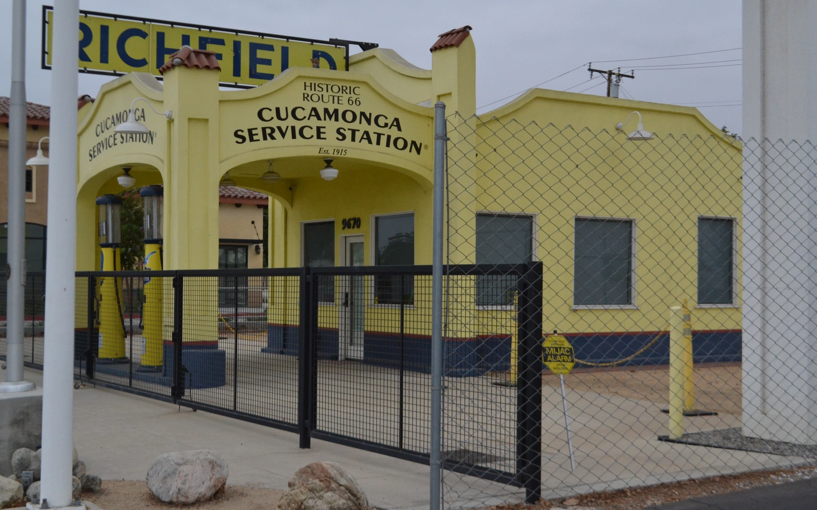 Restored yellow Cucamonga Service Station beside Historic Route 66